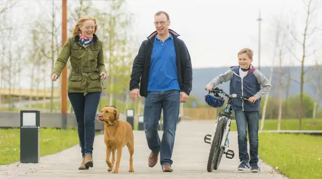 Dog walkers and bike at Inverness Campus