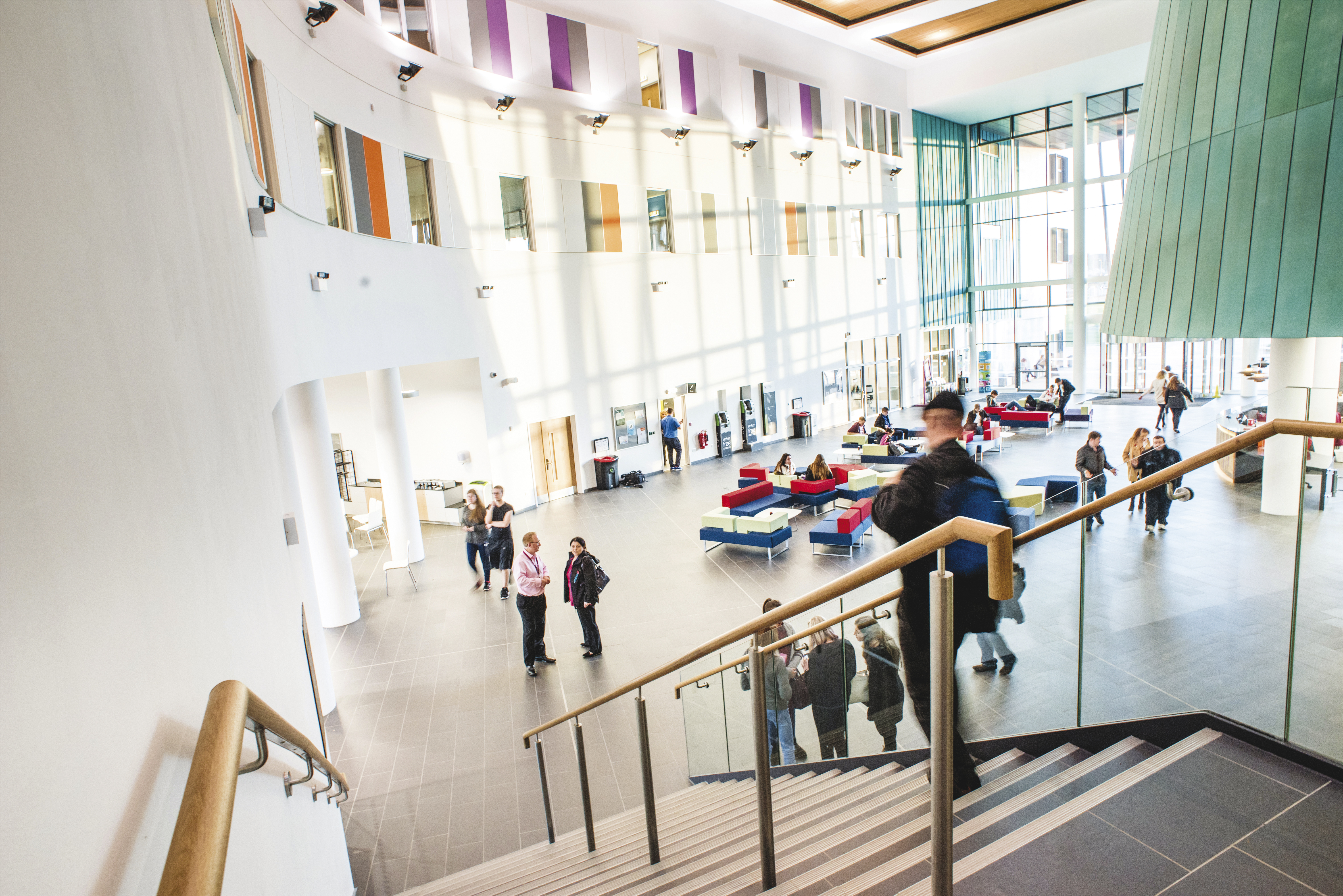Interior of UHI college with staircase and students